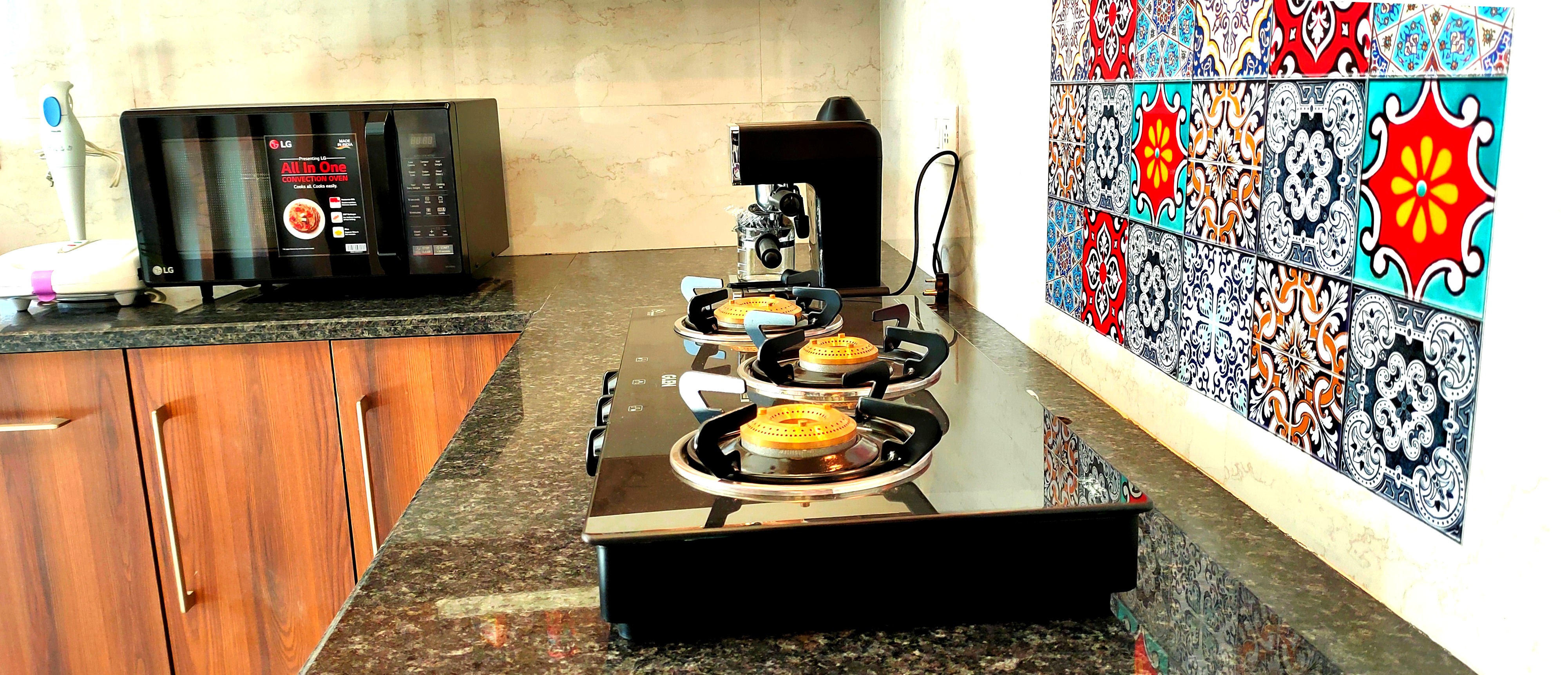 Cooking area with appliances in a Sukh Vaas serviced apartment