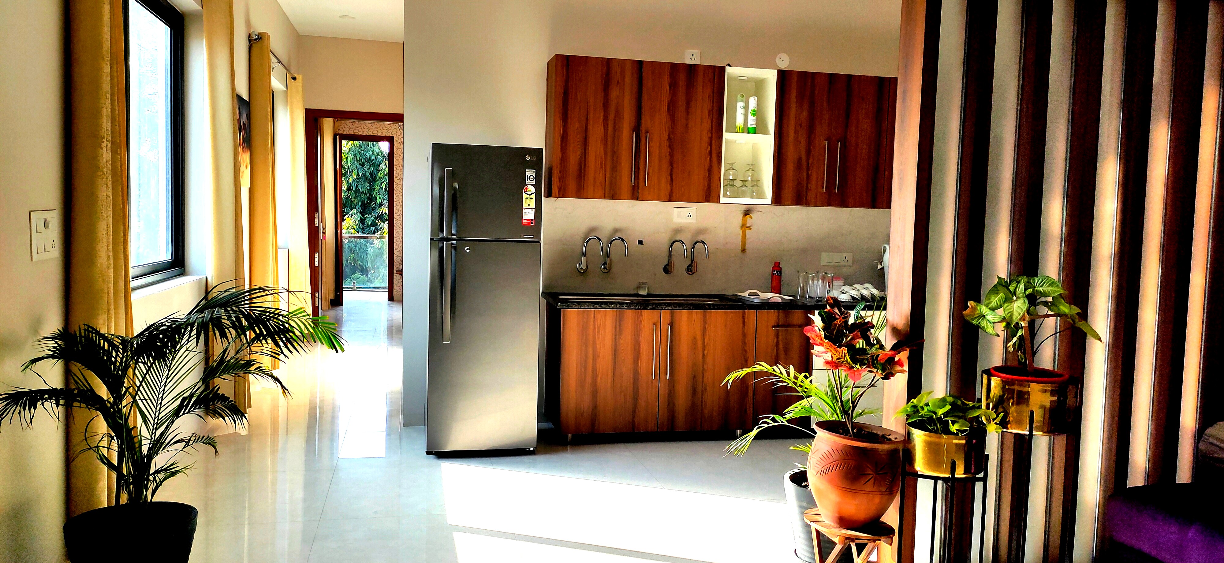Open living and kitchen area of a 2BHK suite at Sukh Vaas